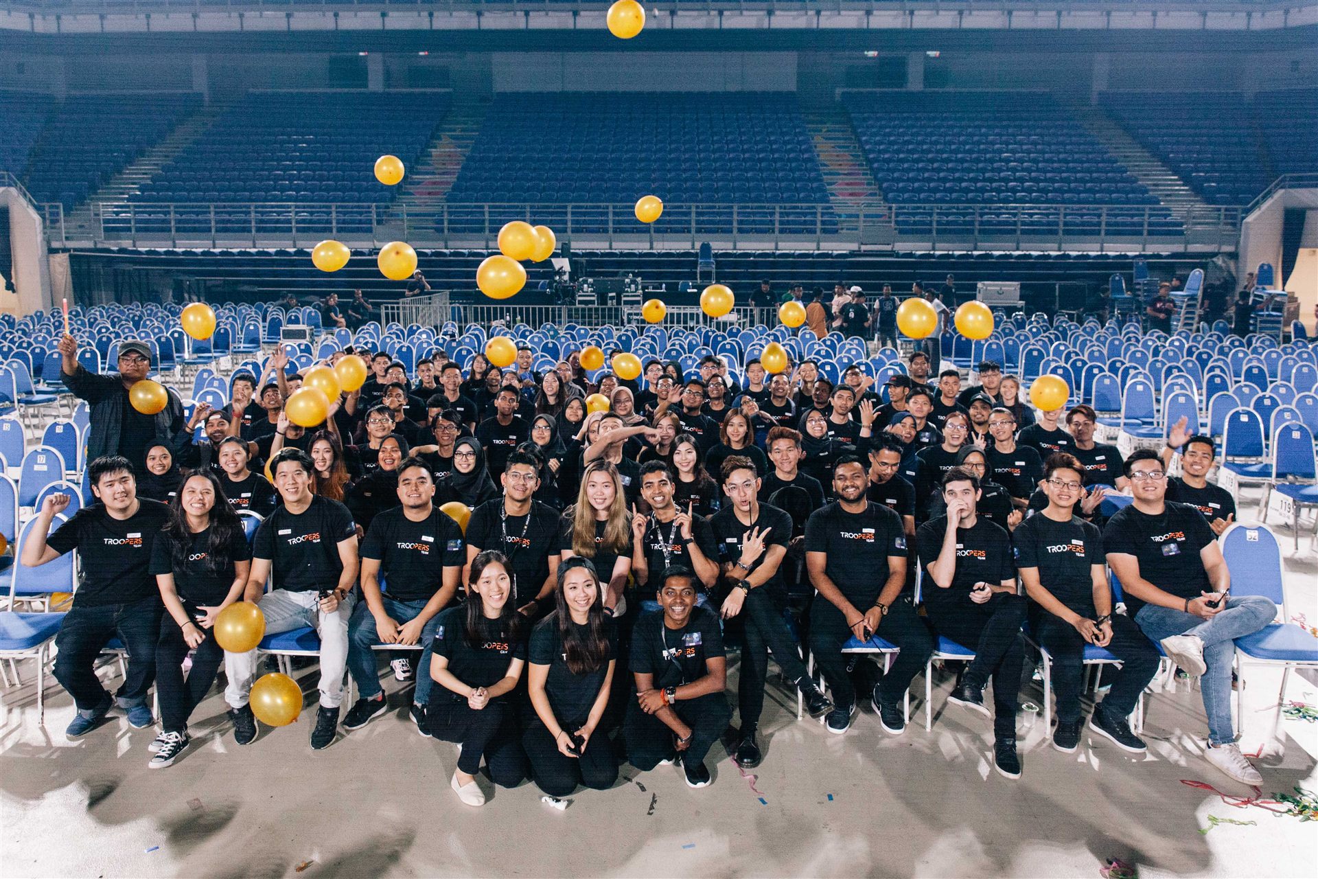 TROOPERS team celebrating with balloons on an empty stadium floor